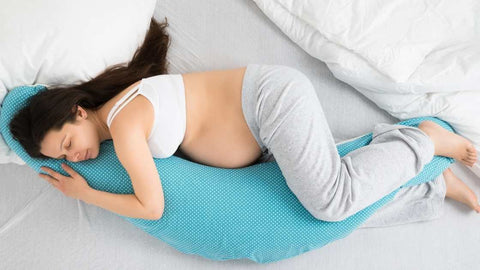 pregnant-women-trying-to-sleep-with-blue-pregnancy-pillow