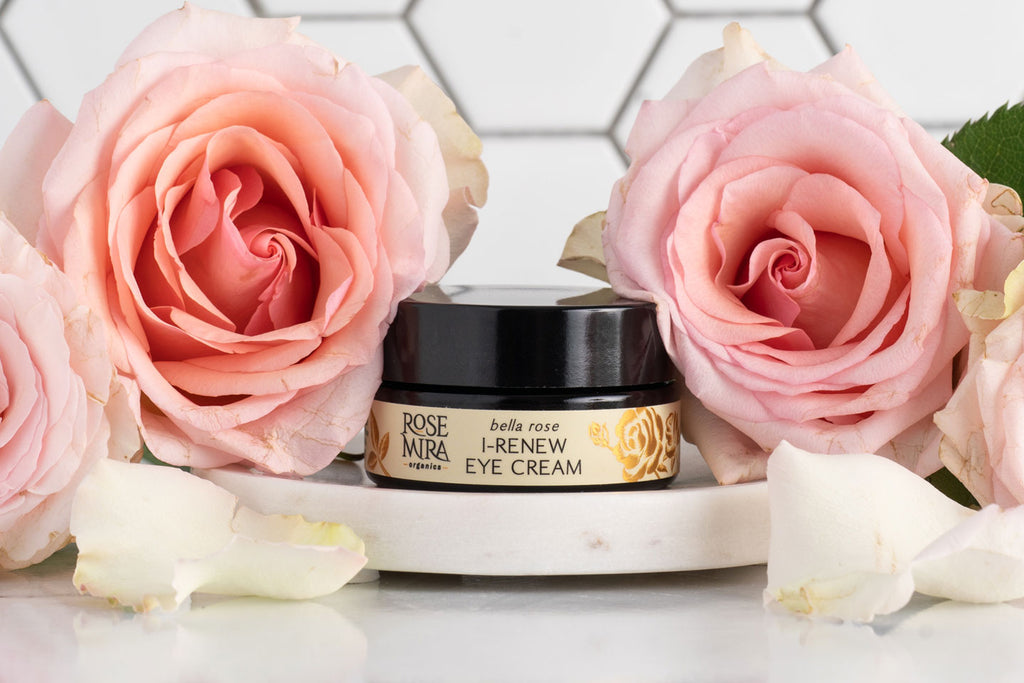 Bella Rose I-Renew Eye Cream with pink roses on a white marble tray.