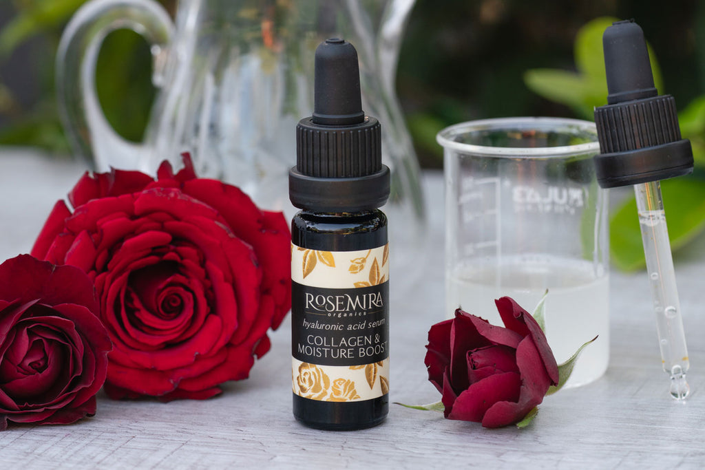 Hyaluronic Acid Serum with red roses and a beaker of hyaluronic acid