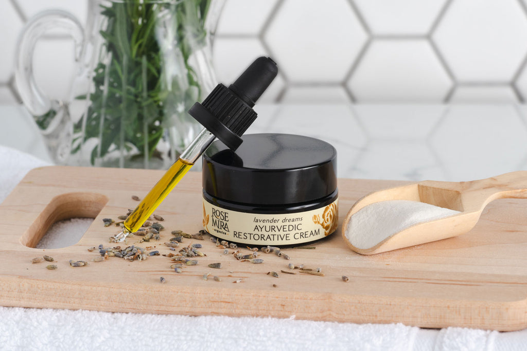 Lavender Dreams - Ayurvedic Restorative Moisturizing Cream with a tincture of gold serum, dried lavender, on a cutting board.