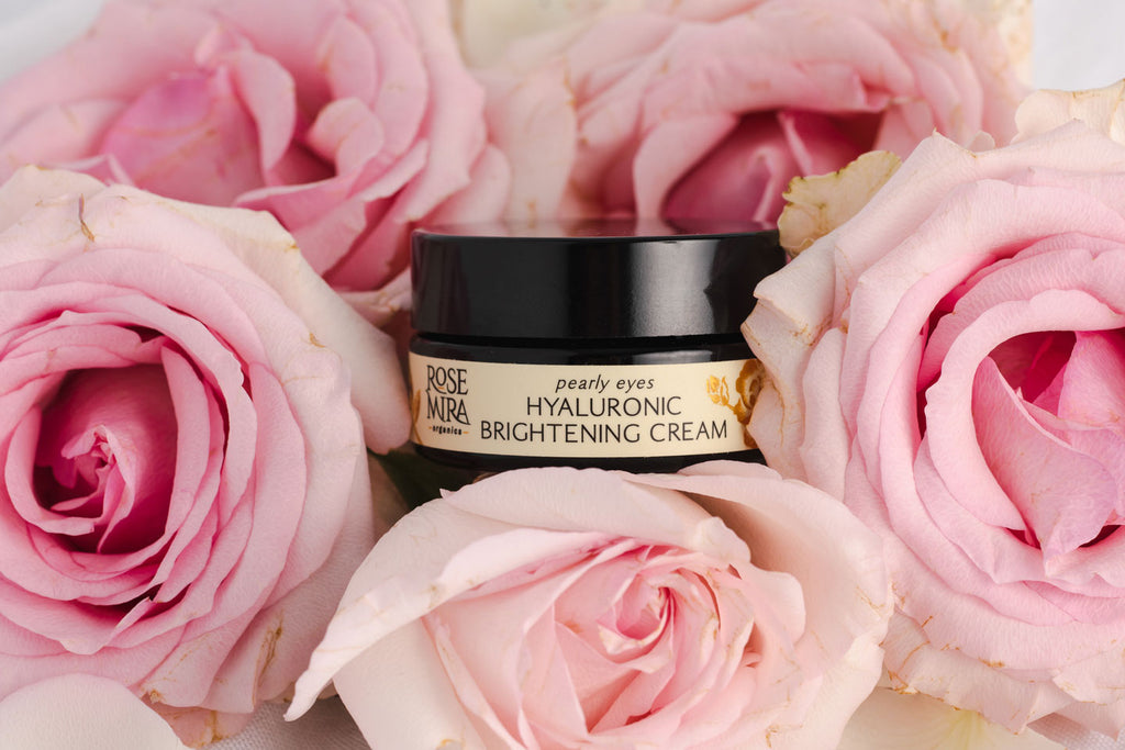 Pearly Eyes - Hyaluronic Brightening Eye Cream tucked into a bouquet of pink roses.