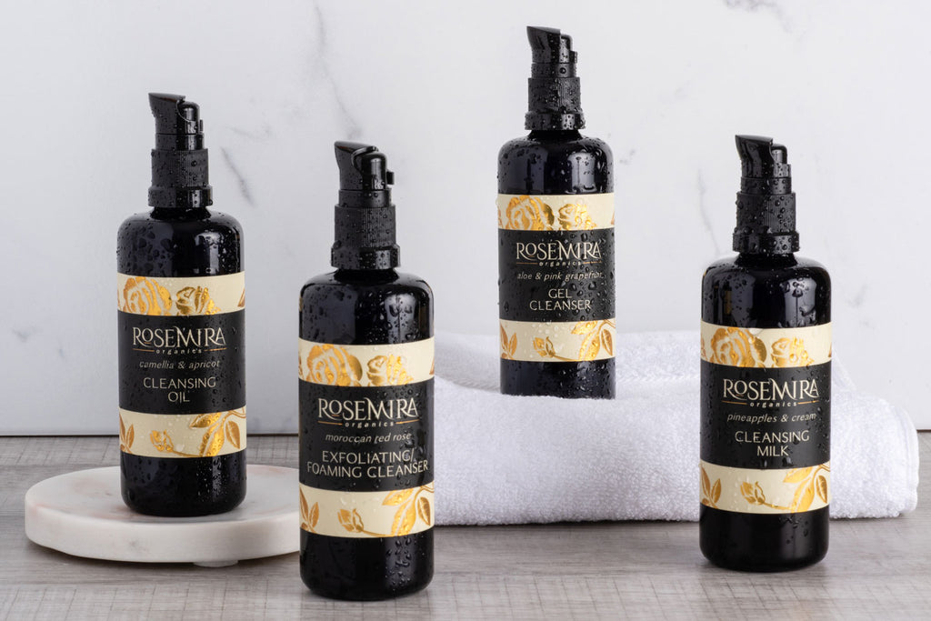 A row of four Rosemira cleansers on a tray and towel.