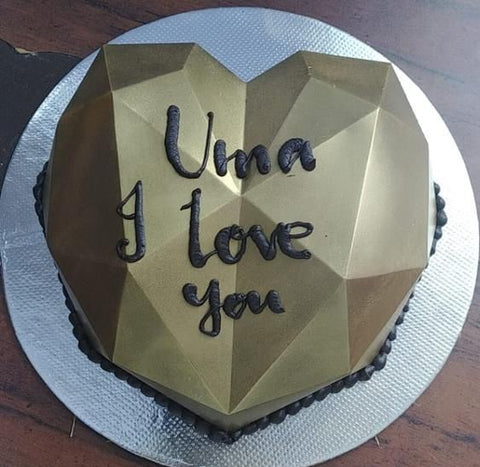 Heart shaped pinata cake with caption "Uma, I love you" for an 83-year-old man who ordered cake for his wedding anniversary for his wife