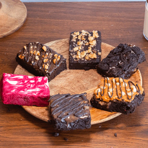 Irresistible eggless brownies in various flavors: Peanut Butter Crunch, Fudgy Walnut, Nutella and Hazelnut, and Red Velvet Swirl. World Chocolate Day. Best Chocolate Goodies. Corporate Office Celebrations.