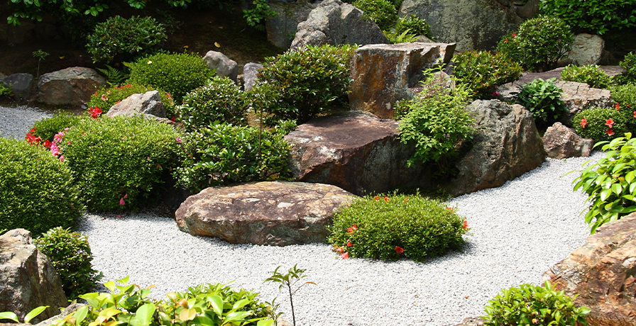 A Zen style garden features plenty of sand, gravel and rock sculptures for a low maintenance, dedicated relaxation zone.