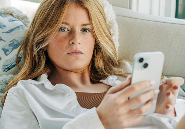 teen girl on her cell phone - Give the Gift Every Woman Wants: A Comfortable Bra