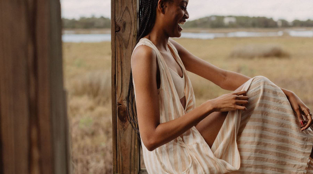 beautiful african american girl sitting on the porch in a tan out fit and beach elli bralette - What Is a Bralette?