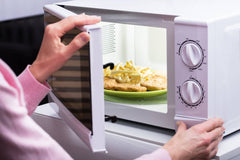 Lady microwaving her food