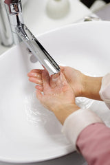 A woman washing her hands with soap