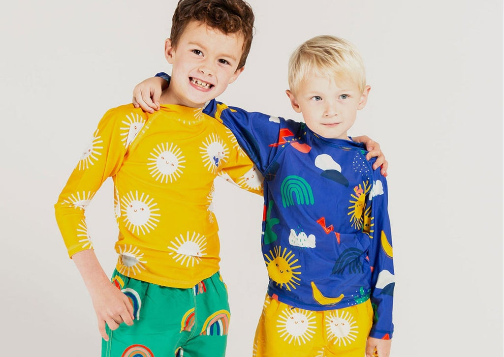 Two boys wearing eco swimwear from one of the top sustainable kids brands, Muddy Puddles