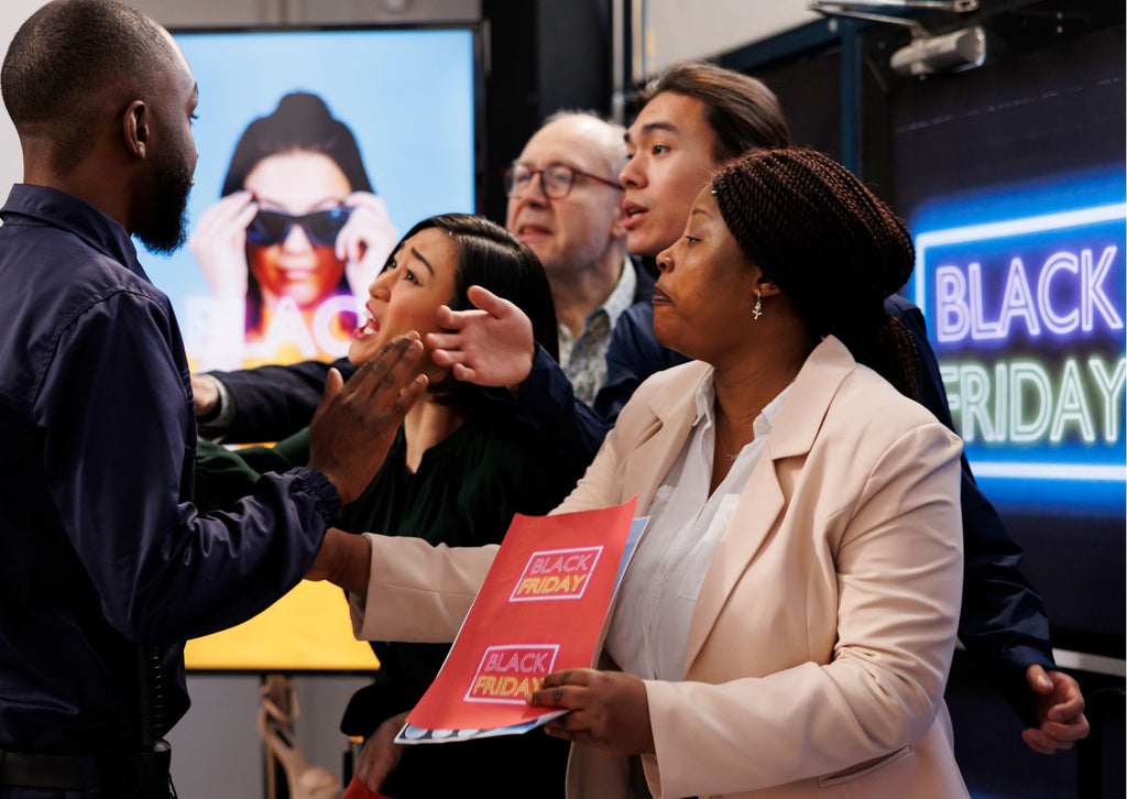 shopper surrounded by sales assistants trying to get his attention