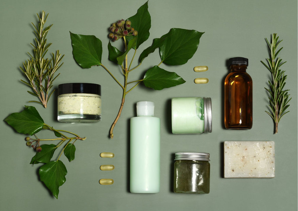 Flatlay of organic beauty products set against a green background