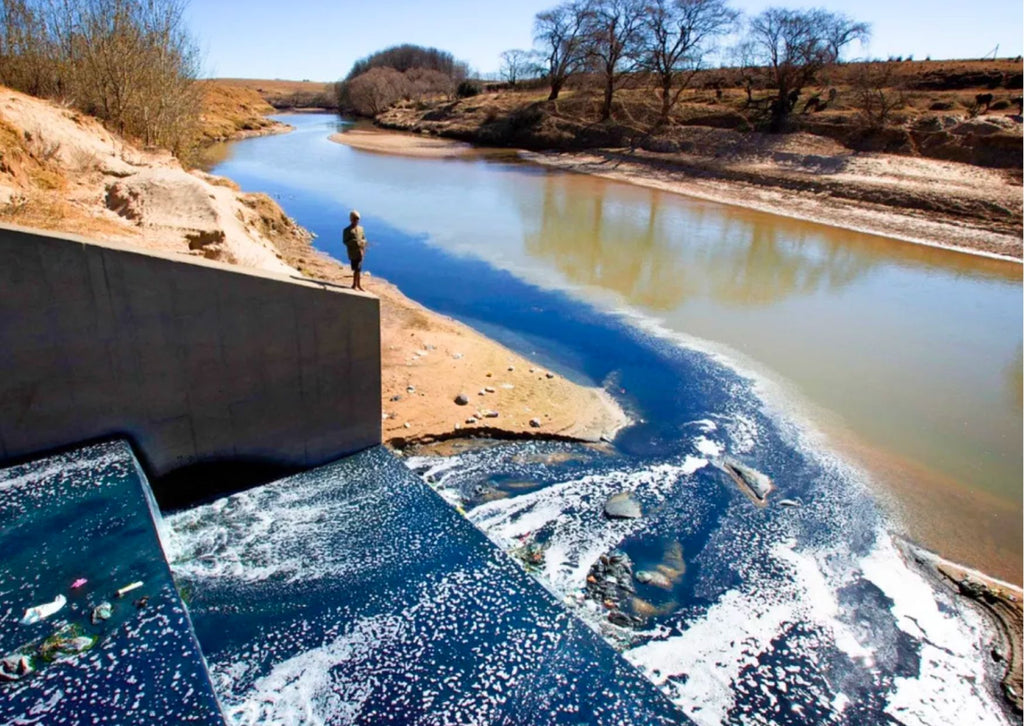 River turning blue from dye in Lesotho from the manufacture of denim