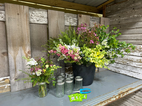 flowers in a bucket with vases