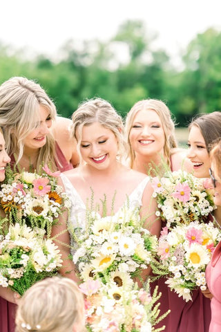 Bride with her bridesmaid holding bouquets