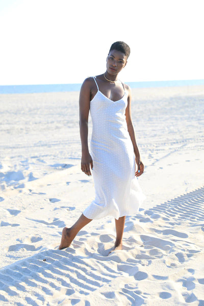 Arielle's white slip milk dress would compliment beautifully a bandeau bikini top