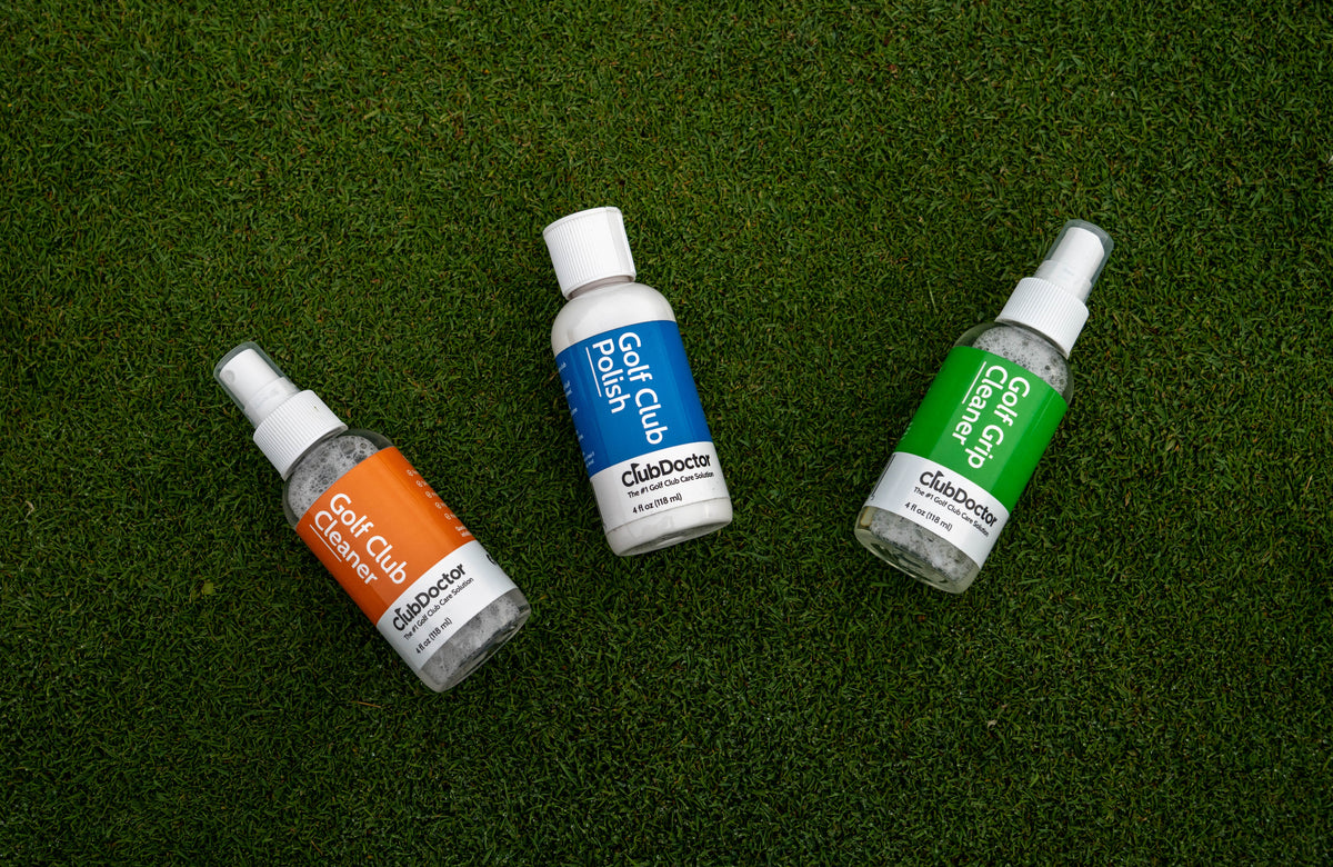 A vibrant and engaging image featuring a trio of Club Doctor products - Golf Club Polish, Golf Club Cleaner, and Golf Grip Cleaner, thoughtfully arranged on a lush bed of golf course grass, symbolizing a holistic approach to golf club maintenance, ensuring your equipment remains in peak condition, delivering consistent, reliable performance throughout your golfing adventures.