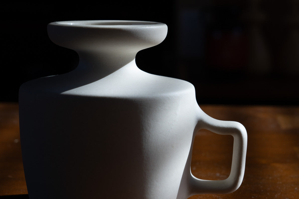 The beautiful silhouette of the vase is the same shape as the mug.