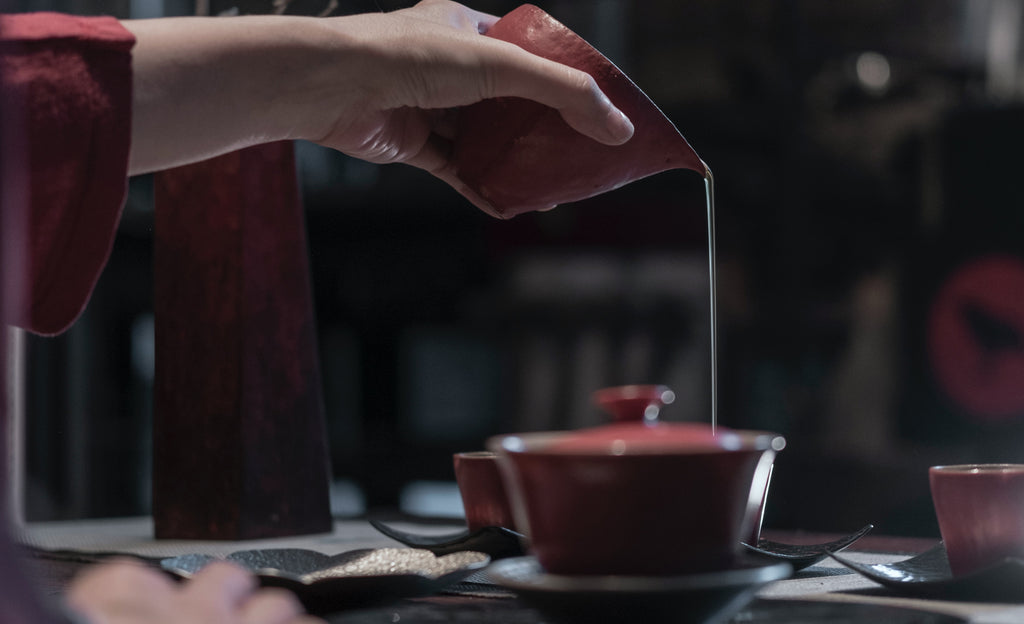 pouring tea, ceramic cups