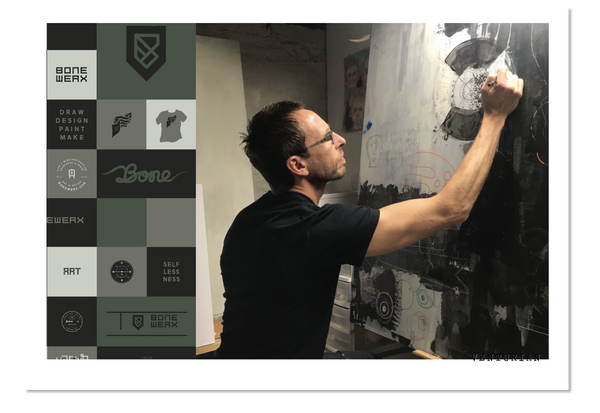 Venturian founder jason strong paints in his art studio alongside some graphic design for the brand boneworx.