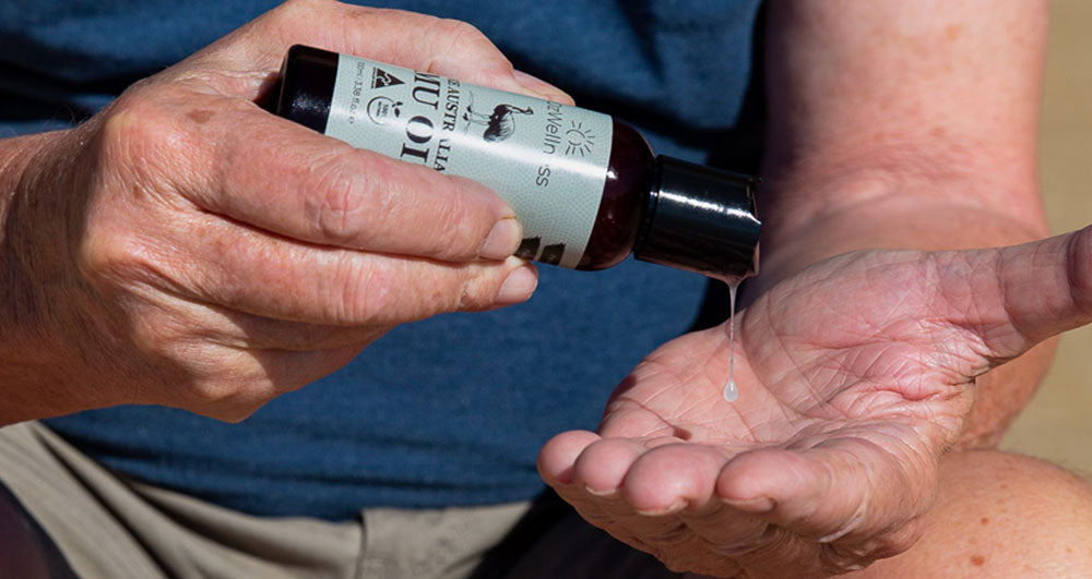 Man pouring emu oil on to hands