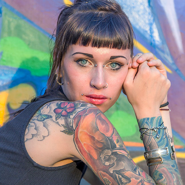 Hipster lady with node piercing and tattoos
