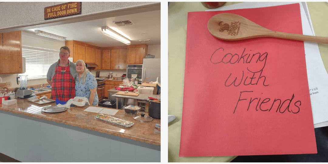 Lori and friend in the kitchen showing the Hungry Squirrel wooden spoon gift