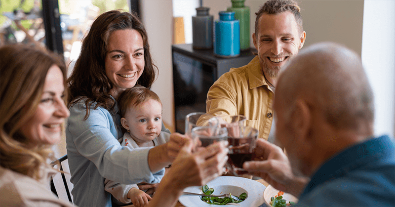 Family on the dinning table toasting wine