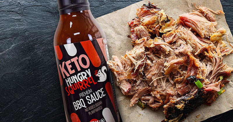 Hungry Squirrel's Premium BBQ Sauce bottle next to pulled pork