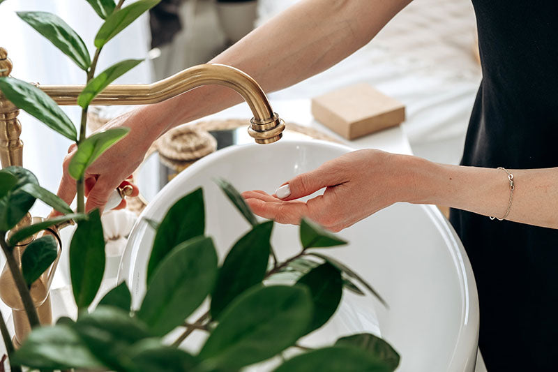 Close up of women going to open water faucet