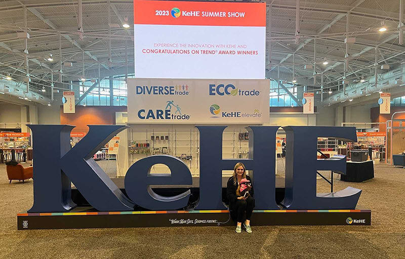 hungry squirrel's rep lady took picture in front of convention sign