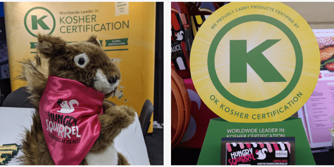 Sammy the squirrel in front of an OK Kosher Certification sign and the OK Kosher certification sign