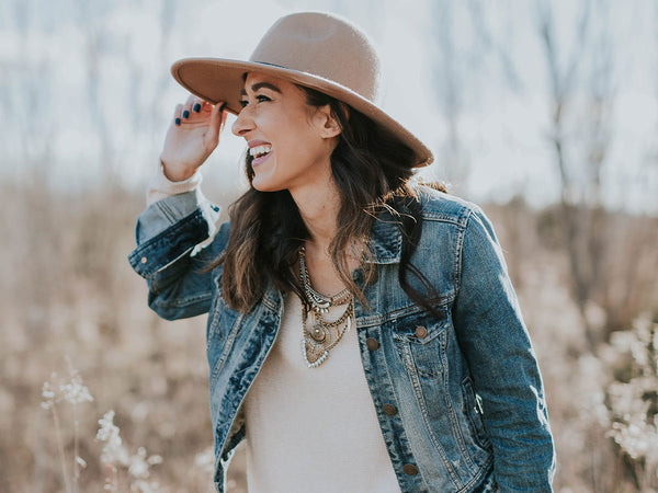 A stylish woman standing outside in the grass