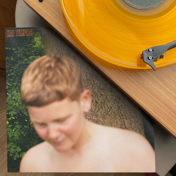 Kae Tempest - The Line Is A Curve - Orange Vinyl playing on record player with cover displayed.