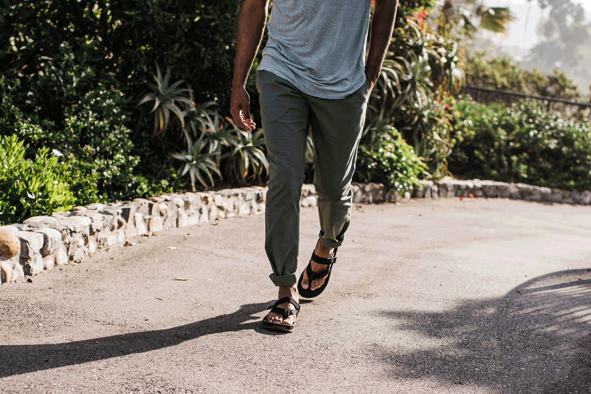 Young man walking up paved driveway