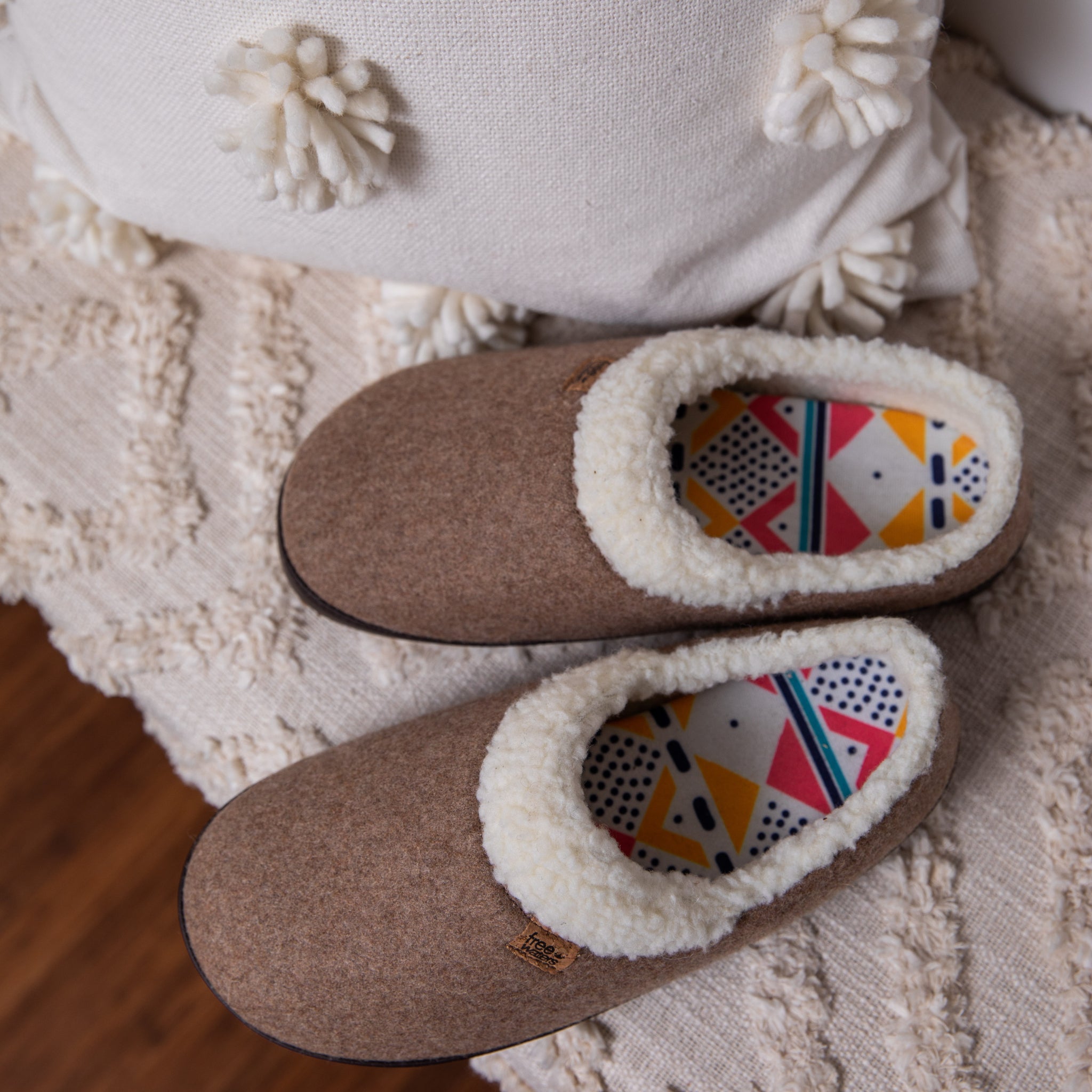 Pair of house shoes on floor on rug