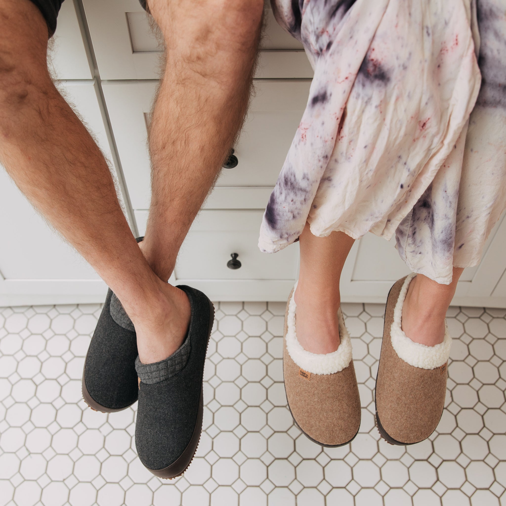 Man and women sitting on kitchen counter top