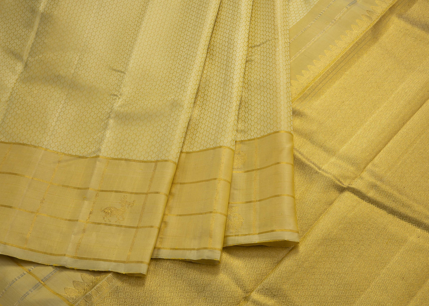 Cream self designed silk saree with checked cream border