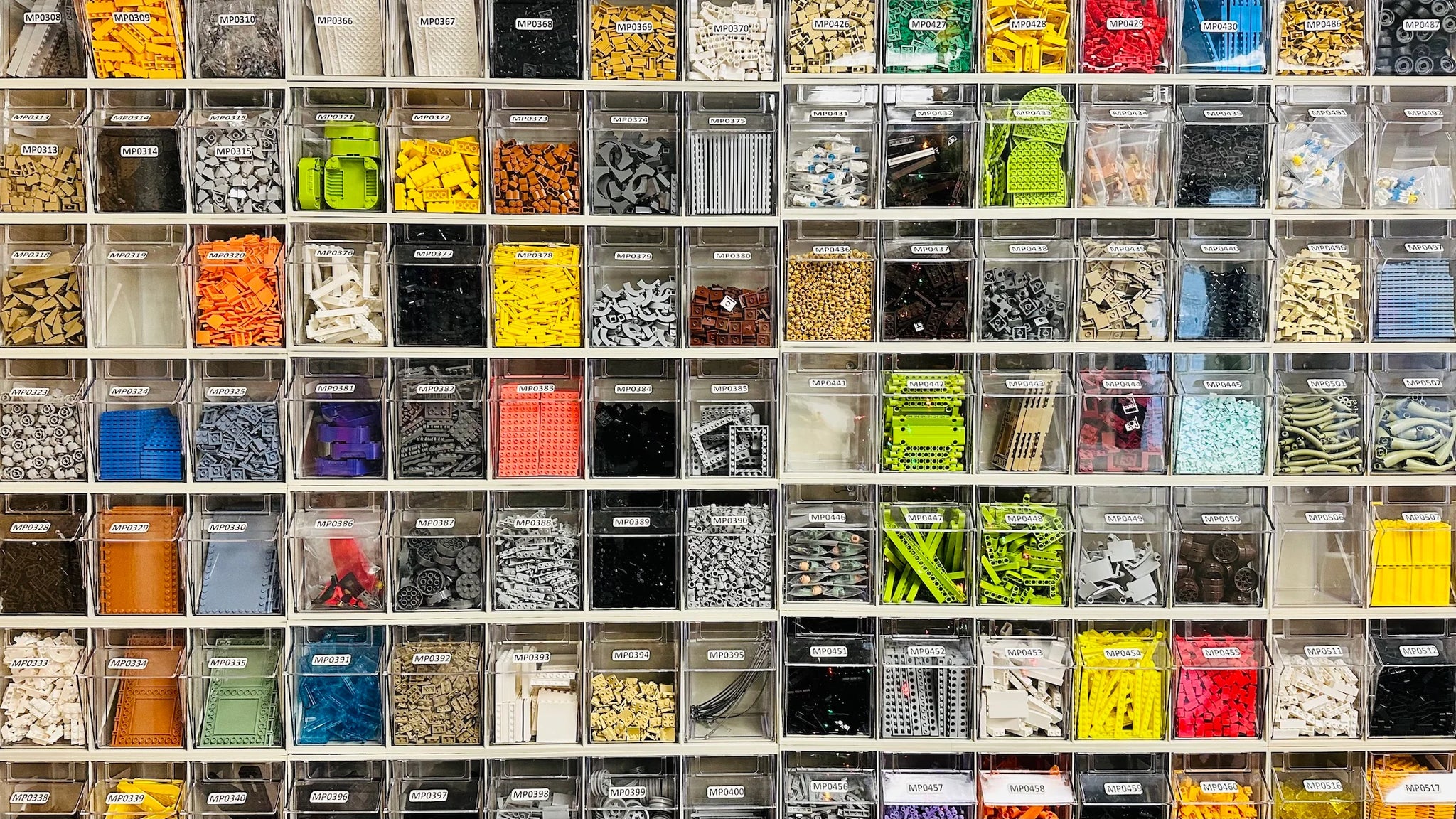 an assortment of lego bricks of all colors and sizes organized neatly into bins
