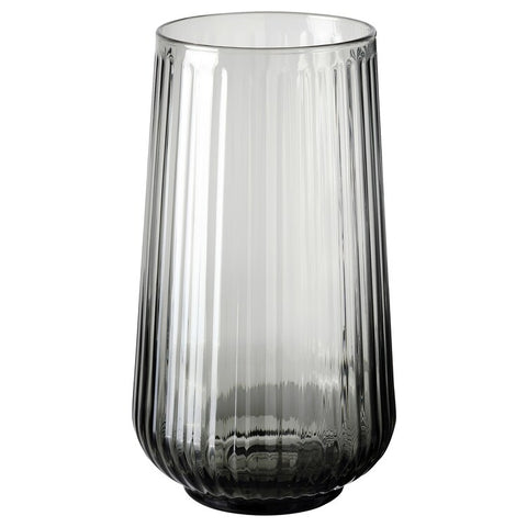 A gray vase with round shapes and grooves.