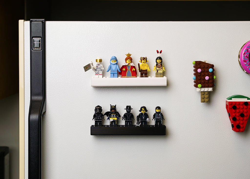 two small minifigure displays on a refrigerator