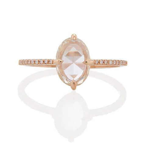 evalina ring features a 0.75 carat oval rose cut white diamond set in a floating prong setting with delicate pavé bands studded with white accent diamonds