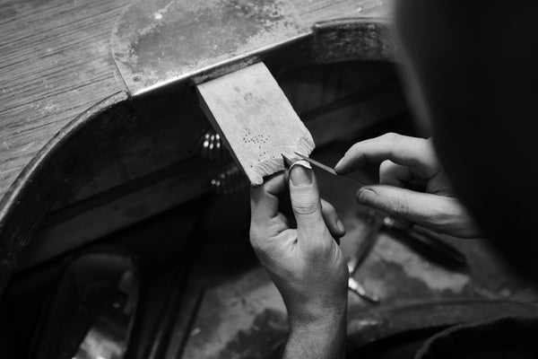 jeweler crafting a silver tiger bracelet