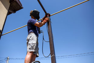 man welding outside in his backyard