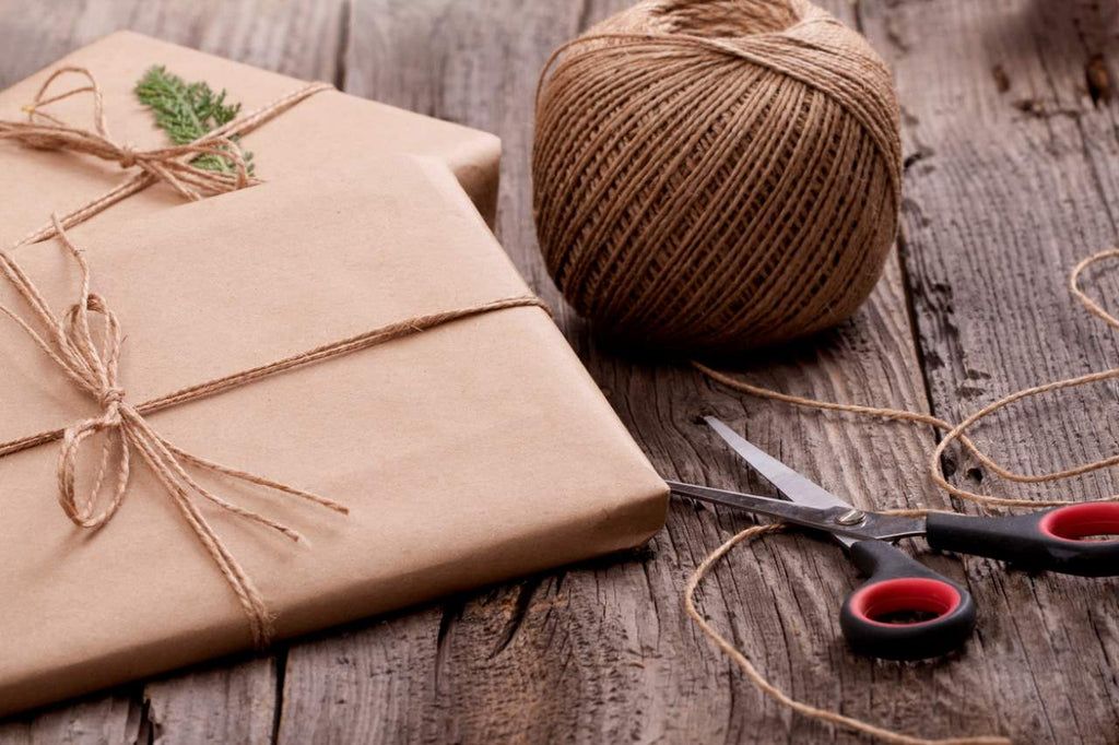 a present wrapped in brown paper and string ribbon