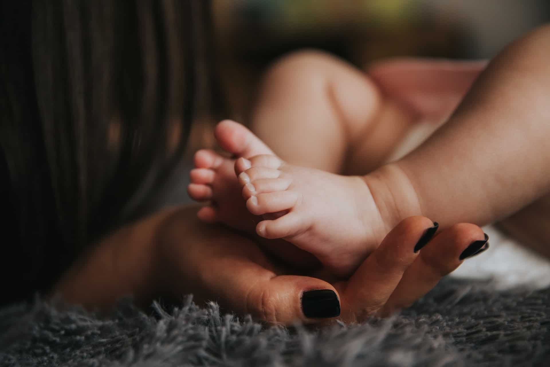 Mother holding baby’s foot