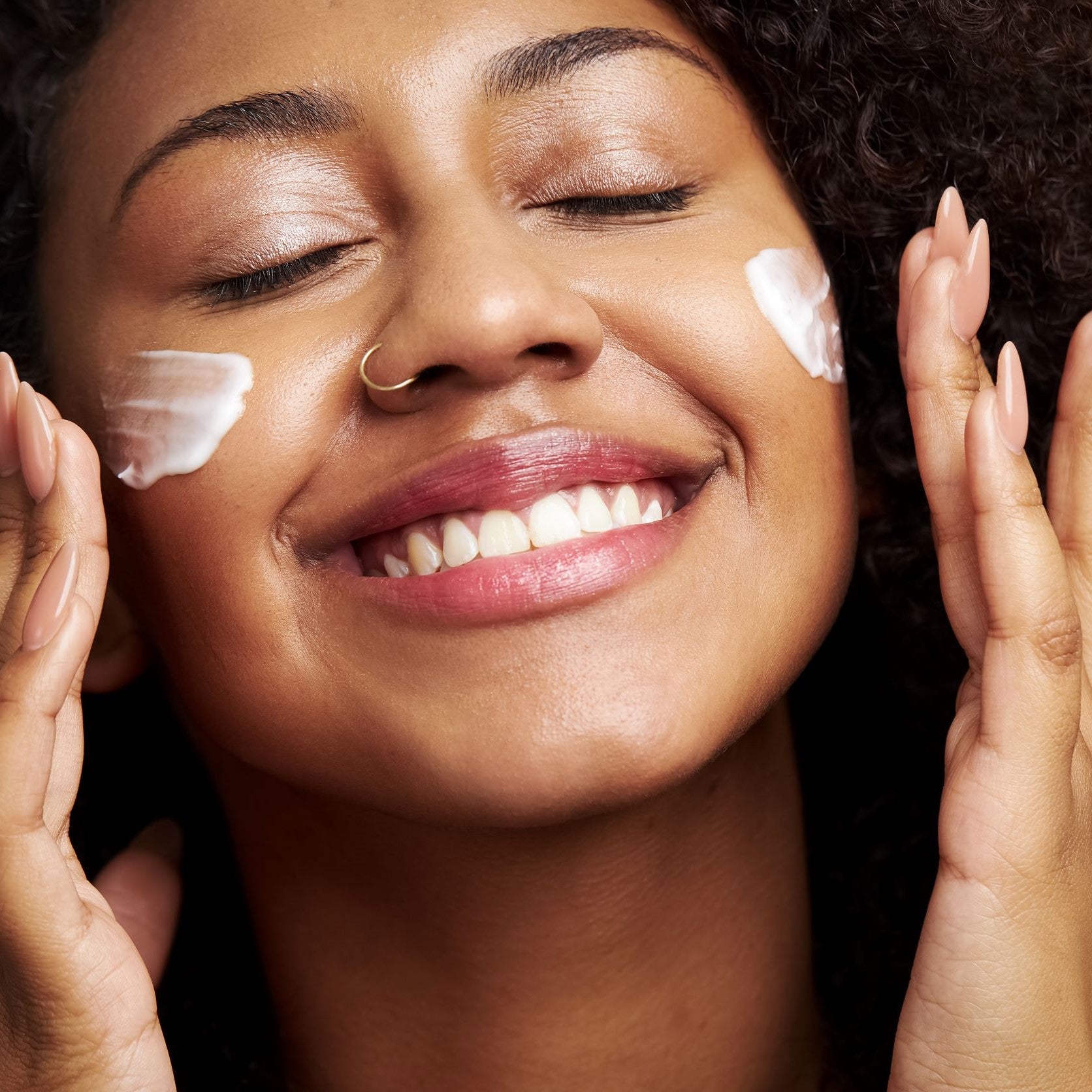 woman applying BALANCING ACT to her face