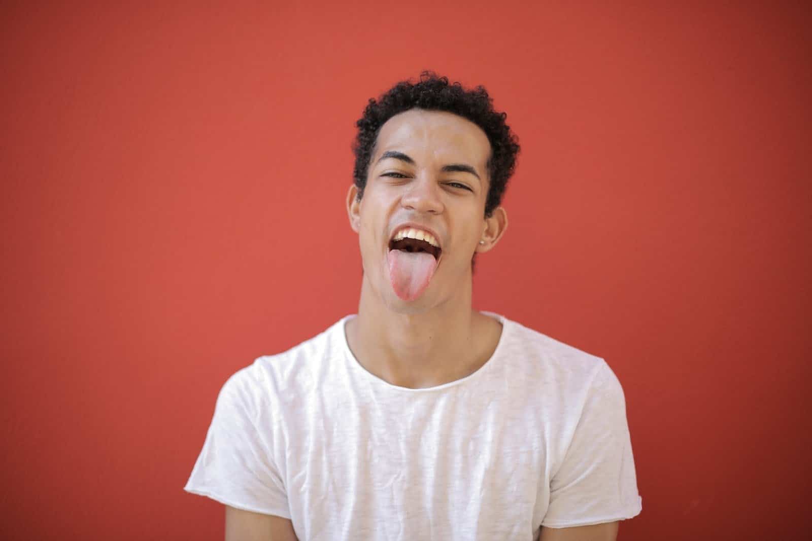 man-in-white-crew-neck-t-shirt-sticking-his-tongue-out