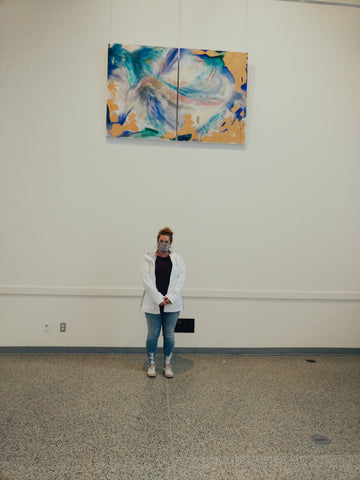 La Seduisante Dragonne painting hung at the Cultural Centre with Melanie Kilsby standing in front