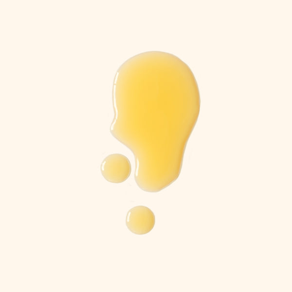 yellow oil droplets on a cream background